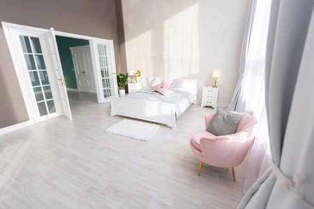 Stylish modern bedroom with a minimalistic design in a luxurious rich, expensive interior of an open-plan apartment in light colors.の写真素材