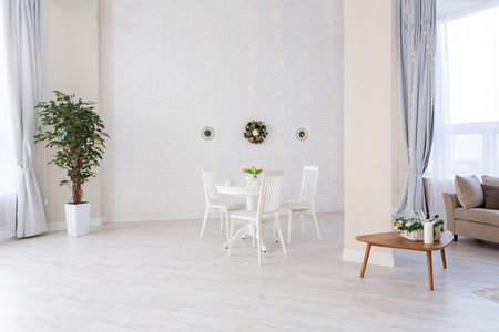 Luxurious and expensive interior of an open-plan apartment in light colors. Stylish modern bedroom with minimal design, dining area and guest space.の写真素材