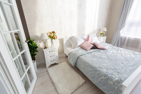 Stylish modern bedroom with a minimalistic design in a luxurious rich, expensive interior of an...