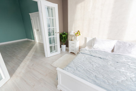 Stylish modern bedroom with a minimalistic design in a luxurious rich, expensive interior of an open-plan apartment in light colors.の写真素材