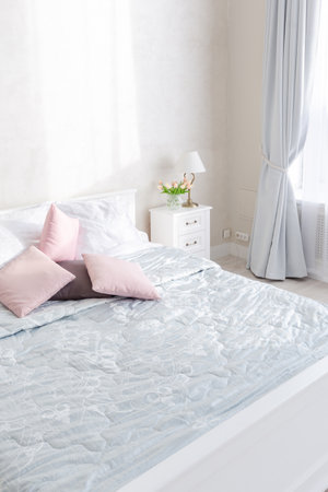 Stylish modern bedroom with a minimalistic design in a luxurious rich, expensive interior of an...