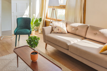 Vintage studio apartment interior in light colors in old style. huge room with large windows with a living room area and a bedroom area. direct sunlight inside.の写真素材