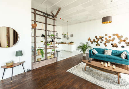 spacious studio apartment decorated with wood and white. Minimalist design with huge windows in the...