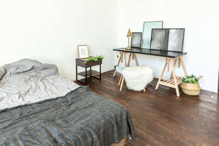 spacious studio apartment decorated with wood and white. Minimalist design with huge windows in the...