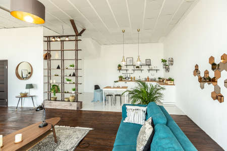 spacious studio apartment decorated with wood and white. Minimalist design with huge windows in the...