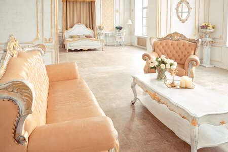 very rich interior of the apartment with golden decorations on the walls in the Baroque style and...