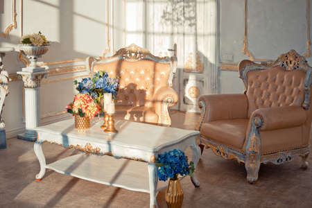 rich apartment interior with golden baroque decorations on the walls and luxury furniture. the room...