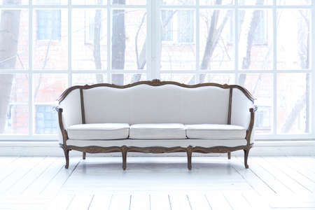 Spacious bright living room with a stylish modern design with elements of antique decor and...