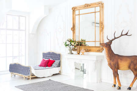 Spacious bright living room with a stylish modern design with elements of antique decor and...