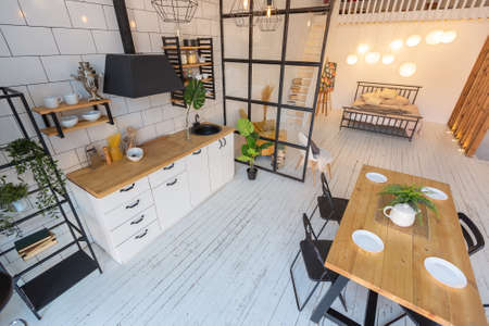 luxury modern design of a cozy small Scandinavian-style studio apartment with white walls, second...
