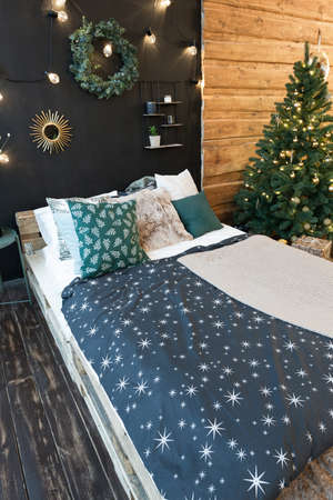 On the eve of the holiday, the interior of the country house is decorated with a New Year tree....