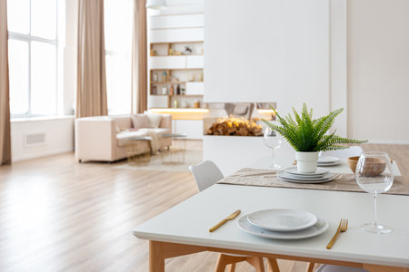 interior design spacious bright studio apartment in Scandinavian style and warm pastel white and beige colors. trendy furniture in the living area and modern details in the kitchen area.の写真素材