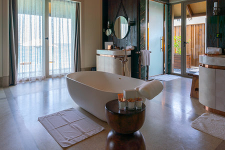 Luxurious interior of a very expensive rich water villa in the Maldives, decorated with natural wood.の写真素材