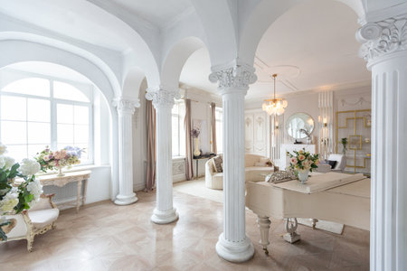 rich luxurious interior of a cozy room with modern stylish furniture nd grand piano, decorated with baroque columns and stucco on the wallsの写真素材