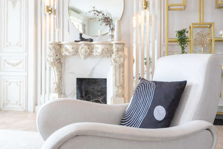 rich luxurious interior of a cozy room with modern stylish furniture nd grand piano, decorated with baroque columns and stucco on the wallsの写真素材