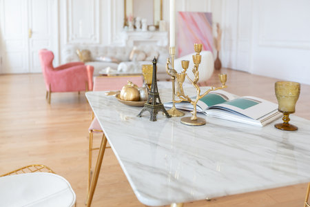 very light baroque style luxury interior of big sitting room. White walls decorated with awesome stucco. Royal style apartment with chic furniture with gold elementsの写真素材