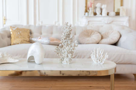 very light baroque style luxury interior of big sitting room. White walls decorated with awesome stucco. Royal style apartment with chic furniture with gold elementsの写真素材