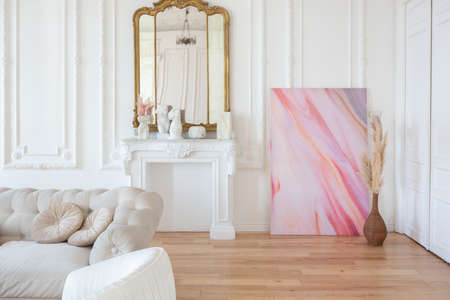 very light baroque style luxury interior of big sitting room. White walls decorated with awesome...