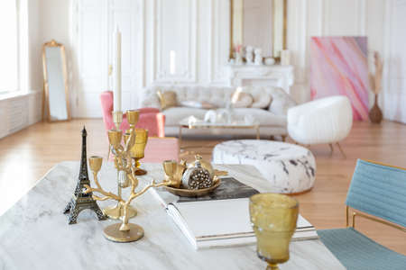 very light baroque style luxury interior of big sitting room. White walls decorated with awesome stucco. Royal style apartment with chic furniture with gold elementsの写真素材