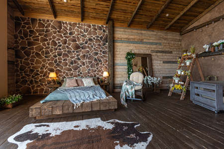 dark cozy interior of big country wooden house, wooden furniture and animal furs. huge panoramic window and very high ceiling.の写真素材