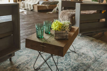 dark cozy interior of big country wooden house, wooden furniture and animal furs. huge panoramic window and very high ceiling.の写真素材