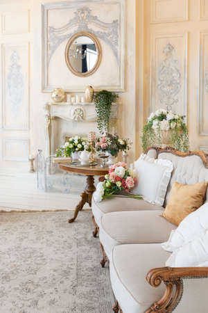 luluxe rich sitting room interior in beige pastel color with antique expensive furniture in baroque...