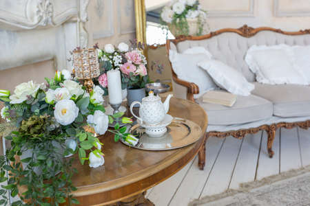 luluxe rich sitting room interior in beige pastel color with antique expensive furniture in baroque...