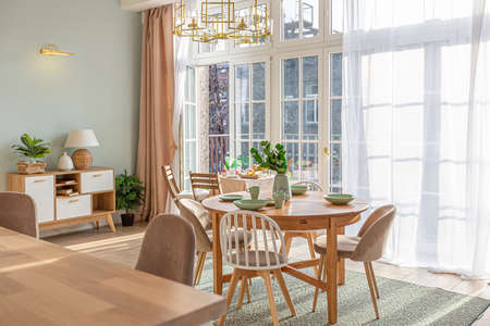 modern expensive luxurious open-plan apartment. Rich Scandinavian-style interior with wooden beams on the ceiling in pastel colorsの写真素材