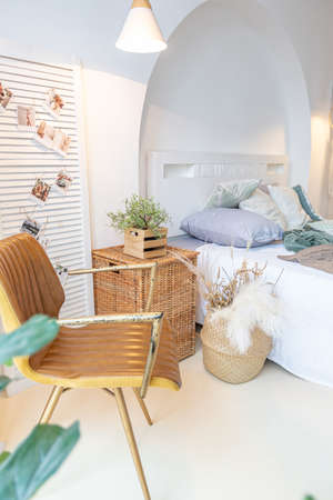 Fashionable modern interior of a light studio apartment with wooden columns in the loft style,...
