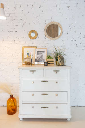 Fashionable modern interior of a light studio apartment with wooden columns in the loft style,...