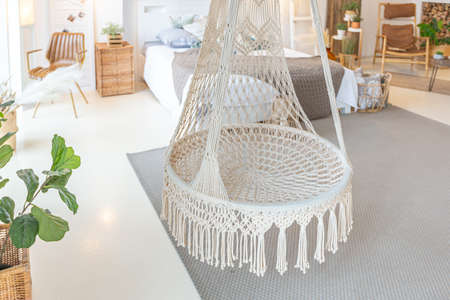 Fashionable modern interior of a light studio apartment with wooden columns in the loft style,...