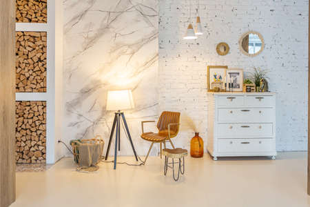 Fashionable modern interior of a light studio apartment with wooden columns in the loft style,...