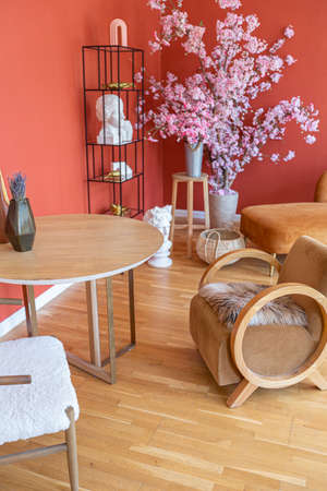 antique vintage interior in 19th century style living room with bright red walls, wood floor and...