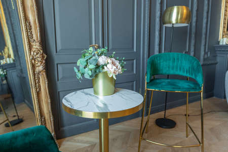 chic interior of the room in the Renaissance style of the 19th century with modern luxury furniture. walls of noble dark color are decorated with stucco and gilded frames, wooden parquet.の写真素材