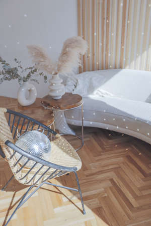 expensive modern light luxury interior design of a spacious living room with wooden elements and white walls. filled with original and unusual decorative thingsの写真素材