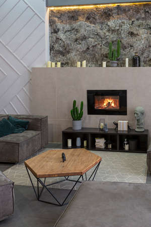 modern studio interior with decorative stone walls in grey. stone wood, tiles and led lighting in...