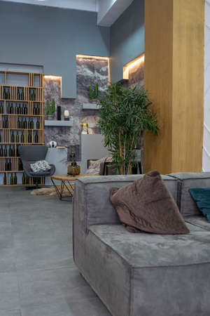 modern sitting place interior design with decorative stone walls in grey. stone wood, tiles and led...