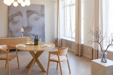 fashionable modern design luxury apartment in light colors. bright day behind huge windows. stylish...