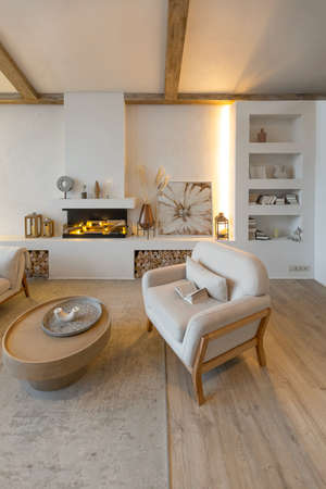 cozy warm home interior of a chic country house with an open plan, wood finishes, warm colors and a family hearth. view of the recreation area for family and guestsの写真素材