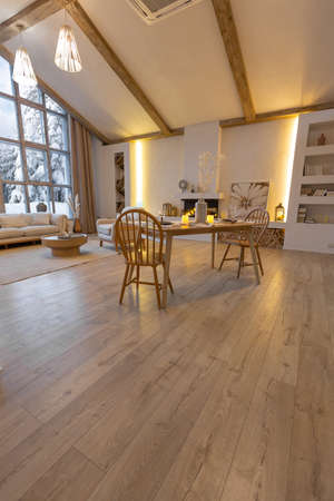 cozy warm home interior of a chic country chalet with a huge panoramic window overlooking the winter...