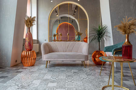 interior of a large apartment in oriental mixed with loft style with arches, led lighting and bright orange elementsの写真素材