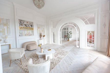 snow-white luxury apartment interior with Egyptian-style decor with light stylish furniture. huge panoramic windows and an archway. minimalism and simplicity with the elegance of modern housing designの写真素材