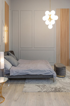 bedroom area in stylish luxury interior of modern studio apartment in green pastel colors with...