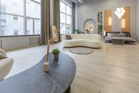 stylish luxury interior of modern studio apartment in green pastel colors with wooden elements....
