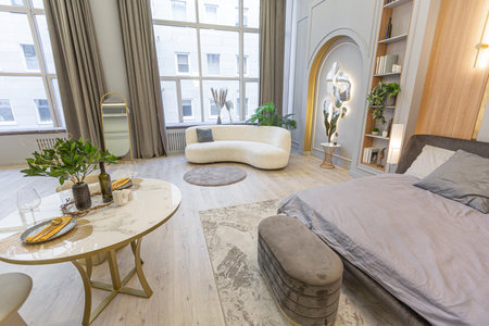 stylish luxury interior of modern studio apartment in green pastel colors with wooden elements. expensive furniture and decorationsの写真素材