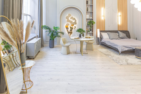 stylish luxury interior of modern studio apartment in green pastel colors with wooden elements....