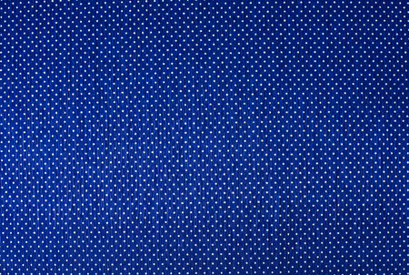 Blue fabric texture with white dots as background. Close-up.の写真素材