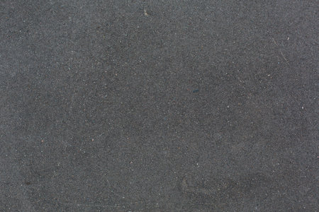 Close up of black sand stone texture for background. High resolution photo.