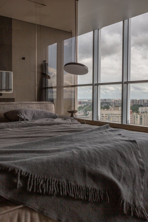 cool expensive interior design of room in prestigious luxury hotel with dark tones with modern LED lighting and stylish furniture. the area with a sink is separated by dark glass from the bedroomの写真素材