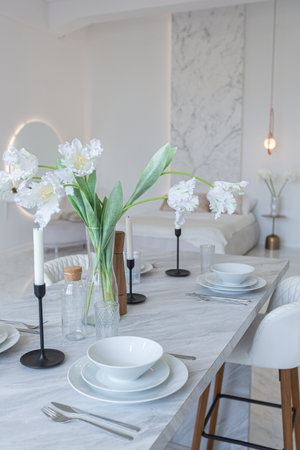 minimalistic light elegant luxury design of a modern spacious studio apartment with kitchen area,...